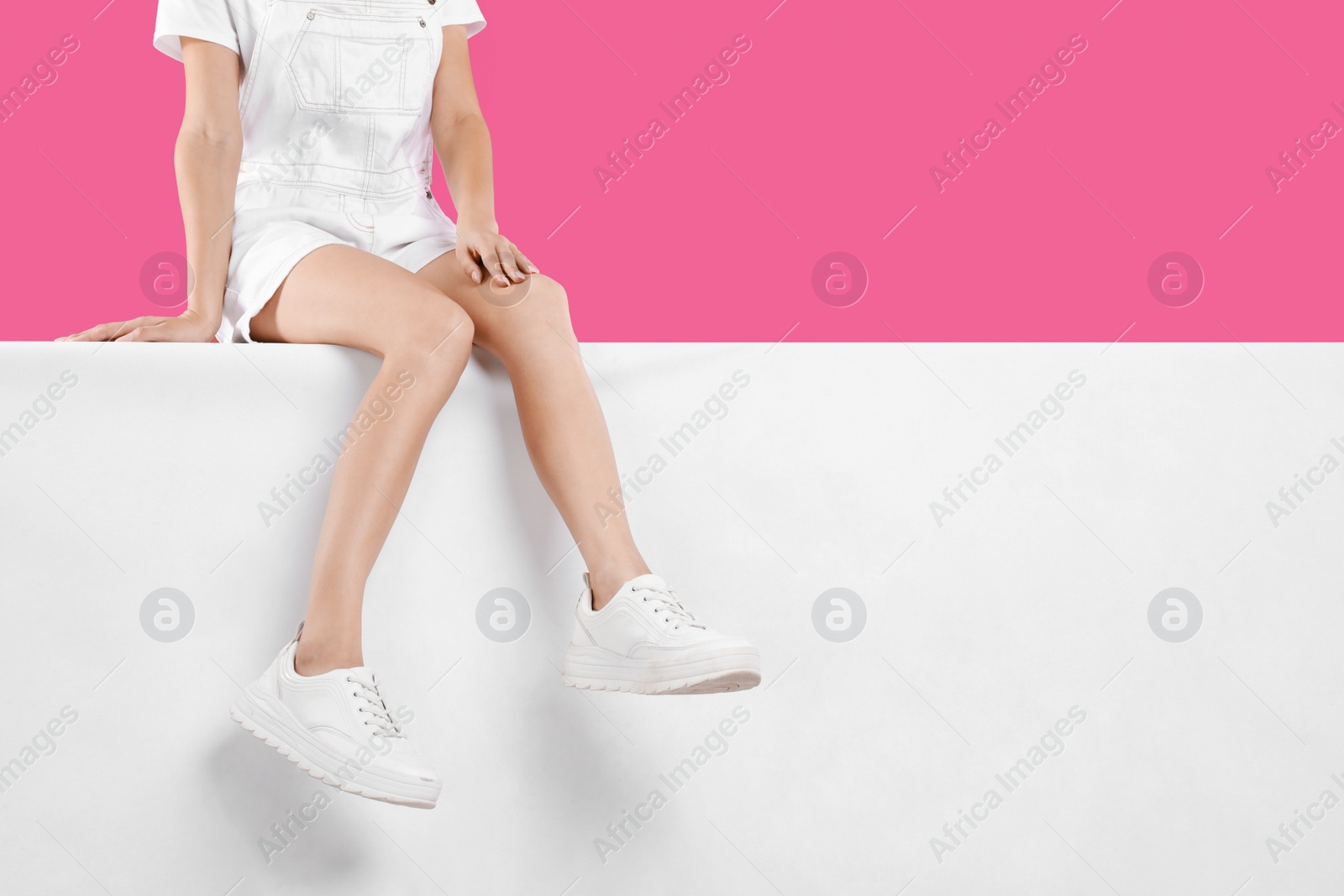 Photo of Woman wearing stylish shoes on color background, closeup