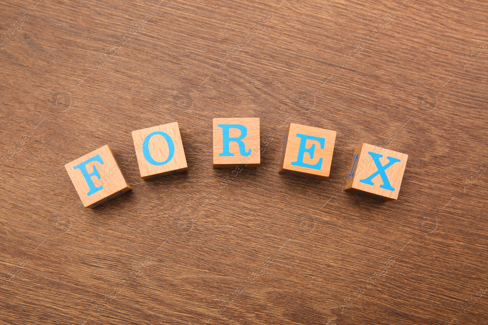 Photo of Word Forex made of cubes with letters on wooden table, top view