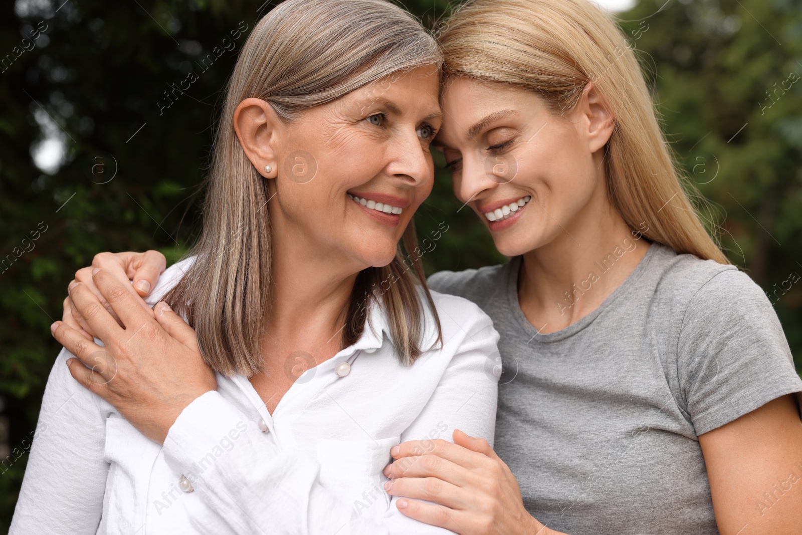 Photo of Happy mature mother and her daughter outdoors