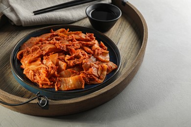 Delicious kimchi with Chinese cabbage and sauce on white table