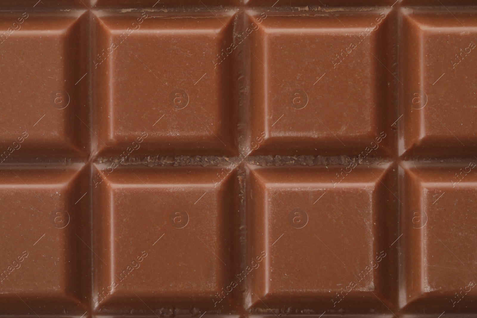 Photo of Delicious milk chocolate as background, closeup view