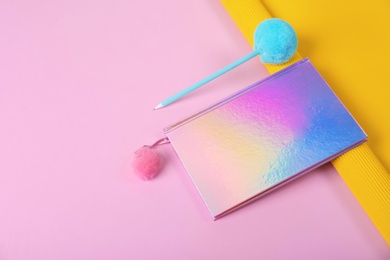 Photo of Beautiful notebook, pen and rolled paper on color background. Space for text