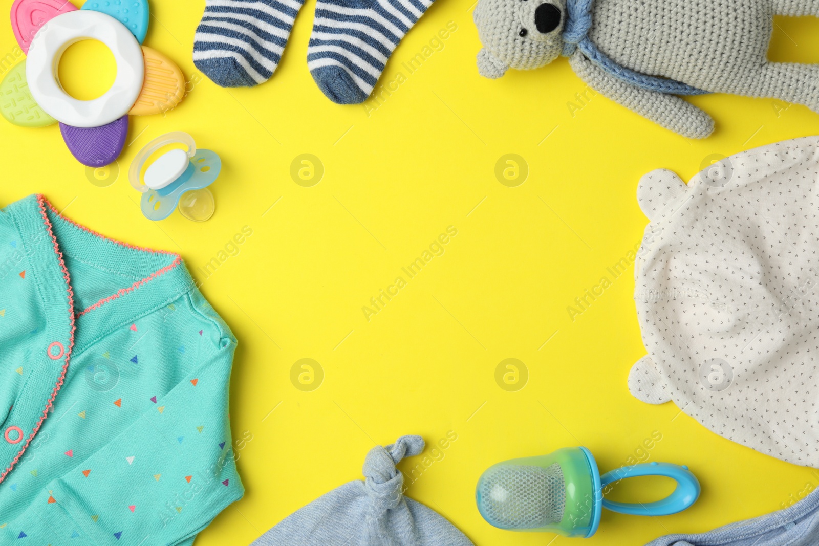 Photo of Flat lay composition with child's clothes and accessories on yellow background, space for text
