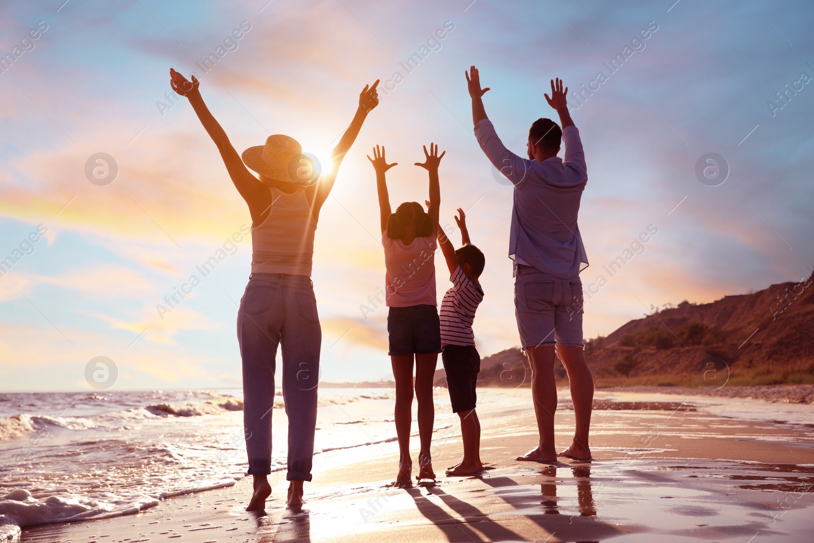 Photo of Family on sandy beach near sea. Summer vacation