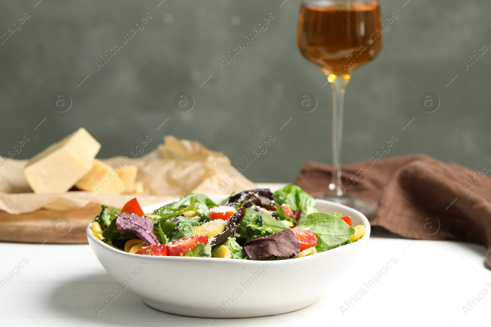 Photo of Delicious fresh carrot salad served on white wooden table. Space for text