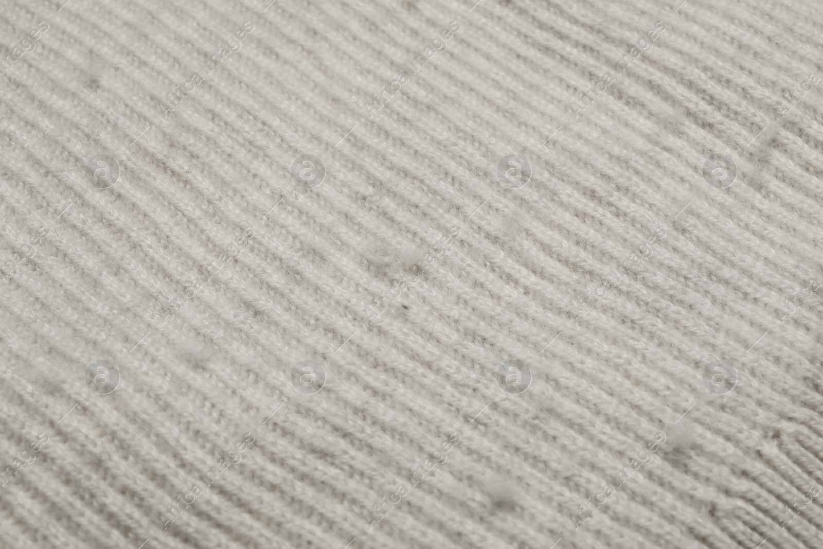 Photo of Light cloth with bobbles, closeup. Before use of fabric shaver