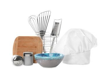 Set of different cooking utensils and chef's hat on white background