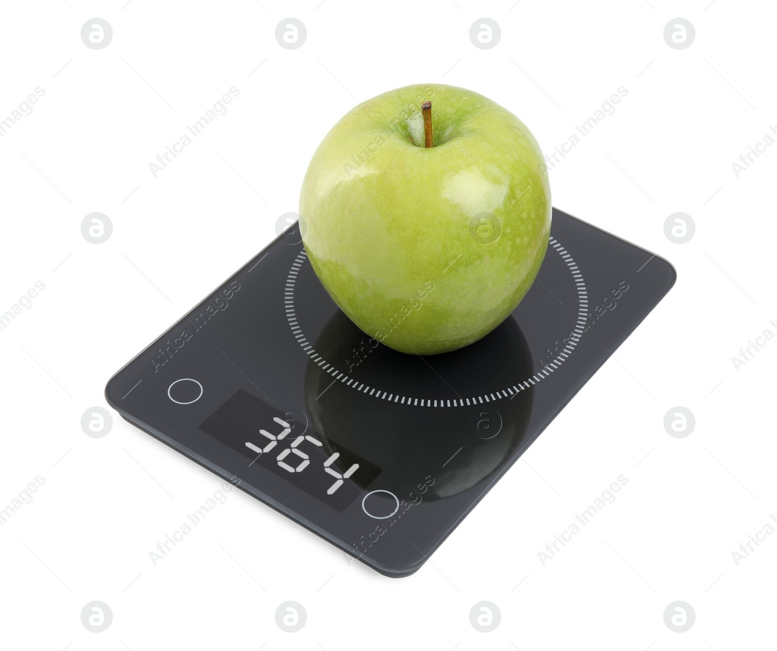 Photo of Ripe green apple and electronic scales on white background