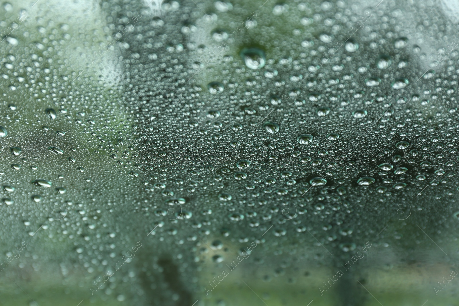 Photo of Road on rainy day, view through wet car window