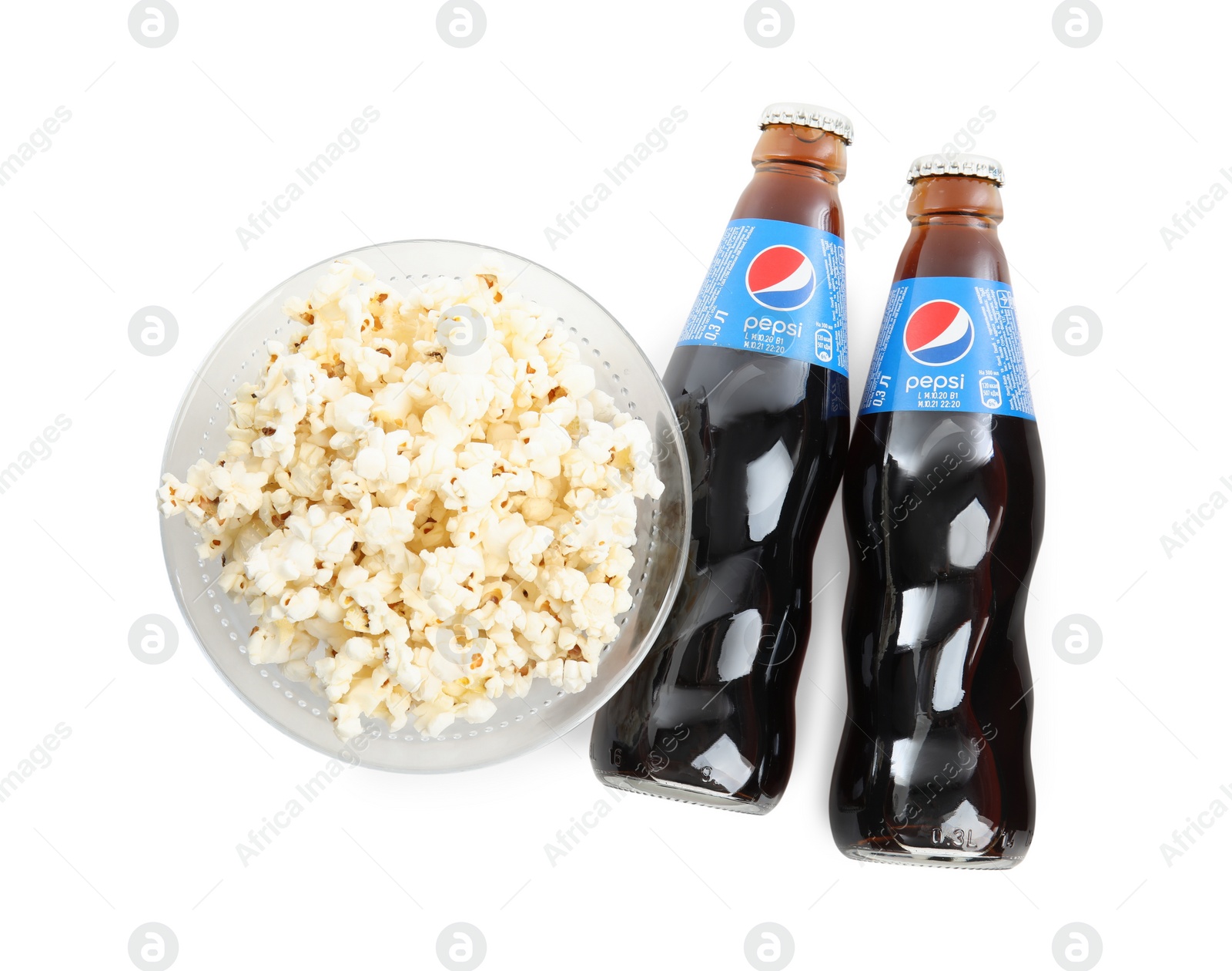 Photo of MYKOLAIV, UKRAINE - FEBRUARY 15, 2021: Glass bottles of Pepsi and snack on white background, top view