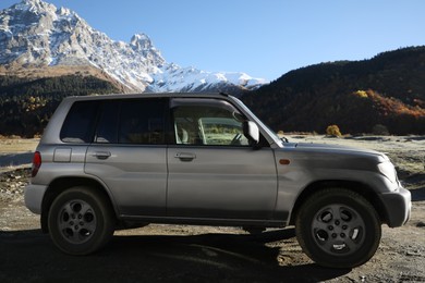 Big car parked in beautiful high mountains on sunny day