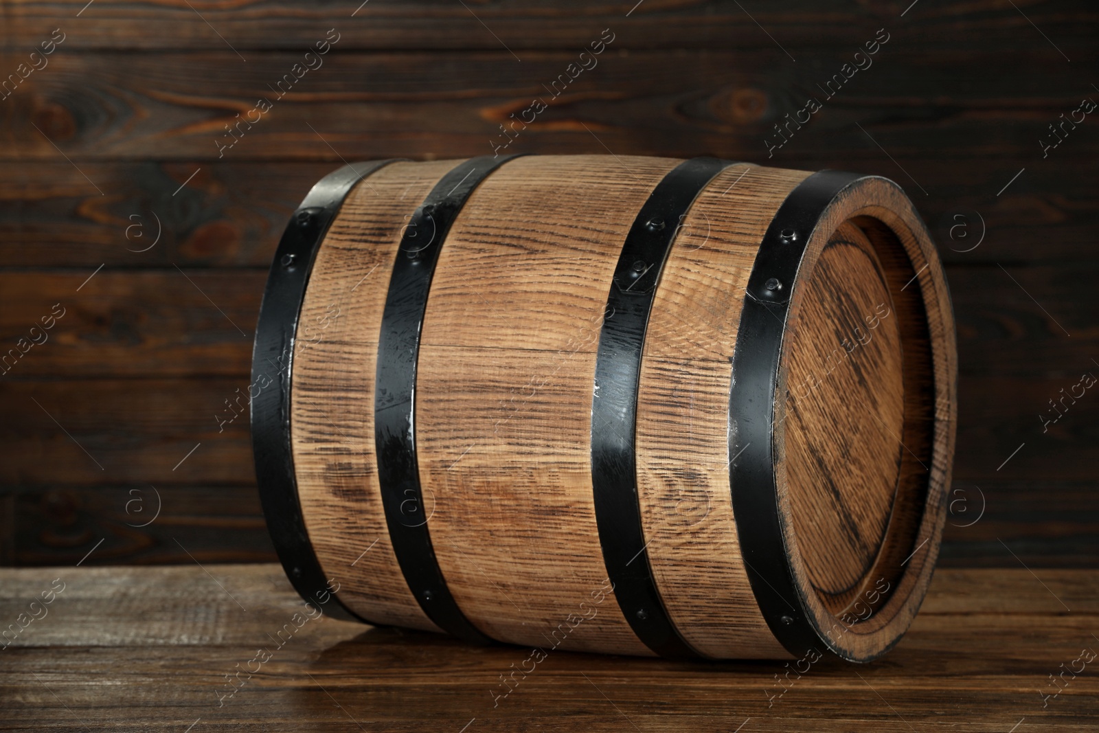 Photo of One wooden barrel on table near wall, closeup