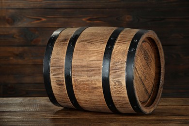 Photo of One wooden barrel on table near wall, closeup