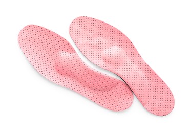 Pink orthopedic insoles isolated on white, top view
