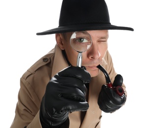 Male detective with smoking pipe looking through magnifying glass on white background