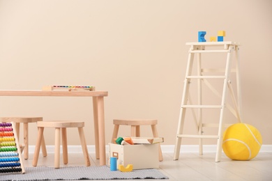 Photo of Stylish child's room interior with toys and new furniture