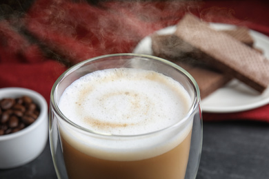 Delicious coffee and wafers for breakfast on grey table, closeup