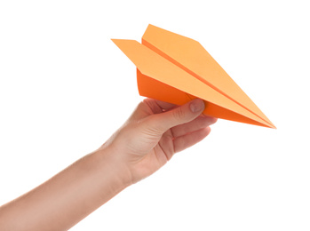 Woman holding orange paper plane on white background, closeup