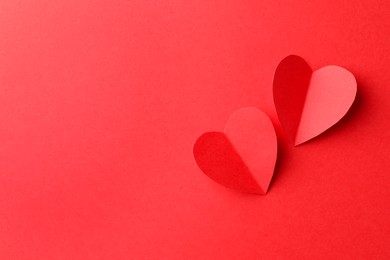 Photo of Paper hearts on red background, flat lay. Space for text