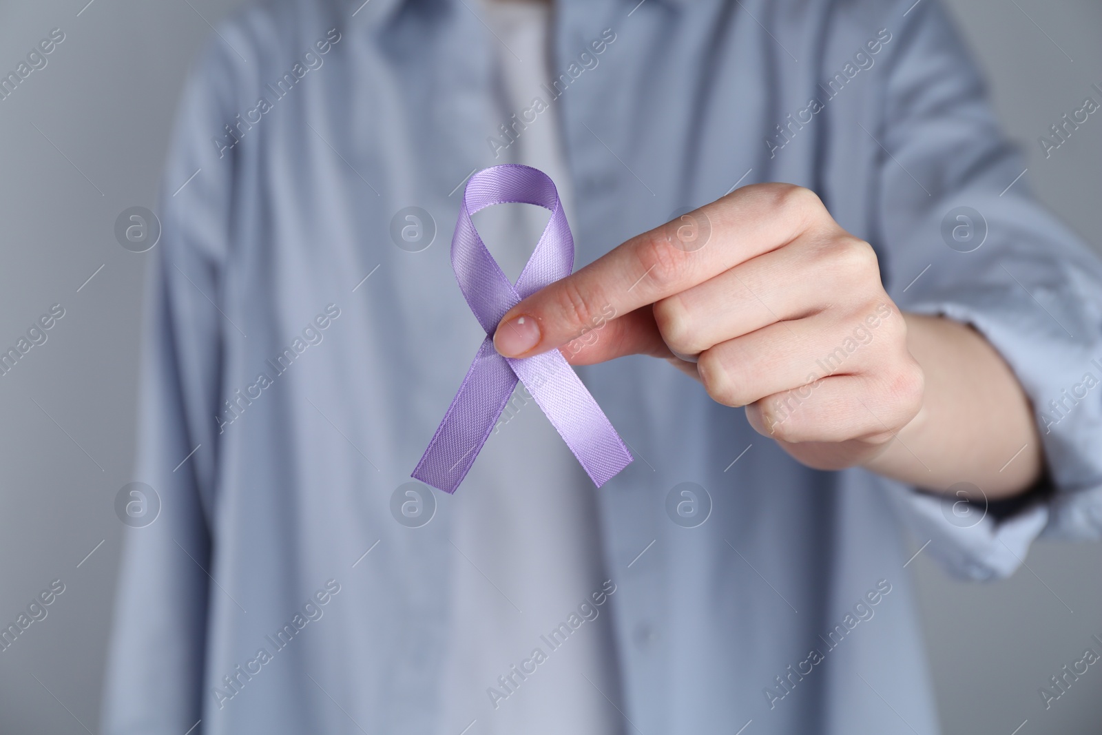 Photo of Woman with violet awareness ribbon on grey background, closeup