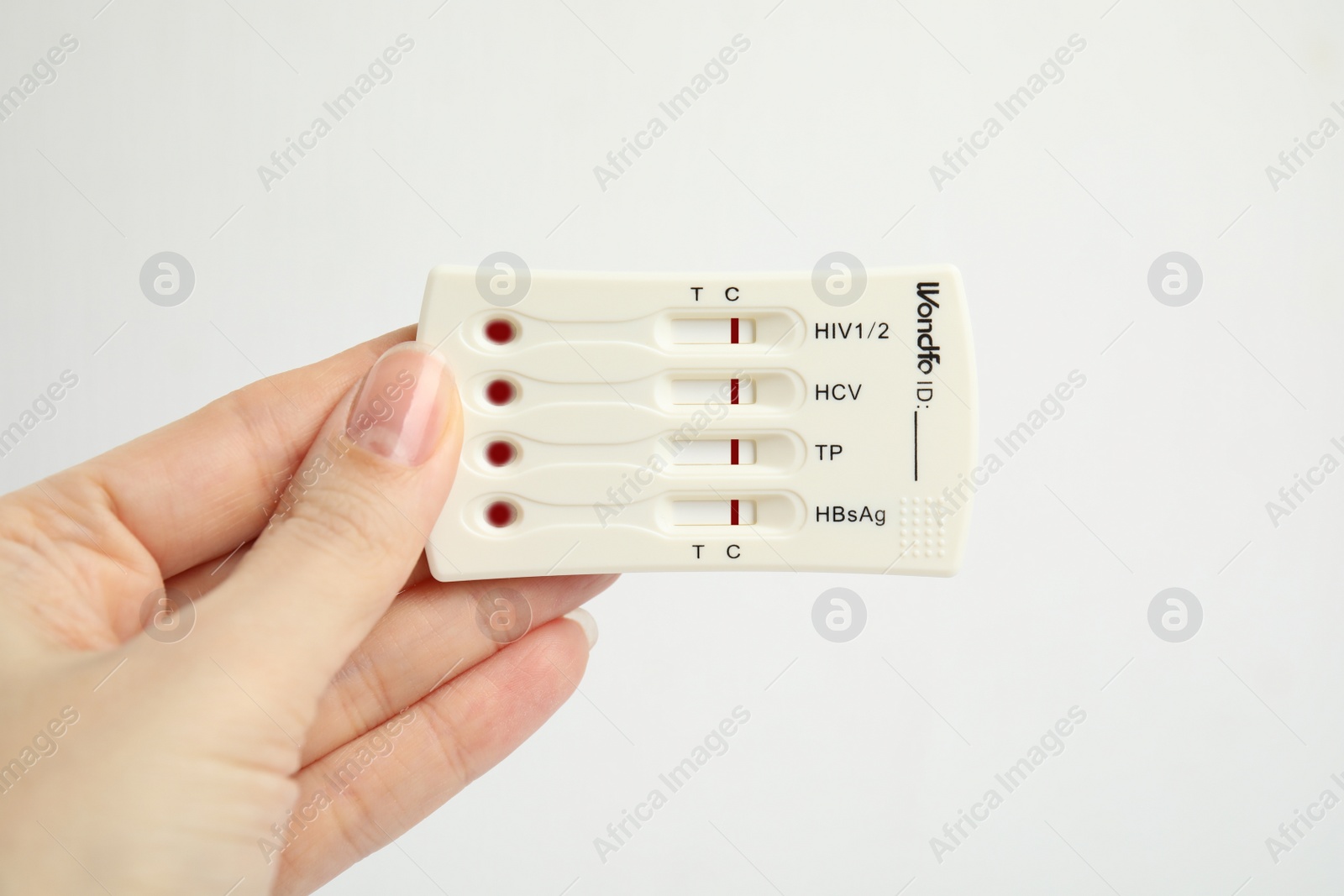 Photo of Woman holding disposable express test for hepatitis on white background, closeup