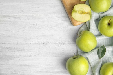 Photo of Flat lay composition of fresh ripe green apples on white wooden table, space for text