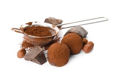 Photo of Delicious chocolate truffles with ingredients on white background