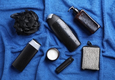 Photo of Flat lay composition with men's cosmetics on blue towel