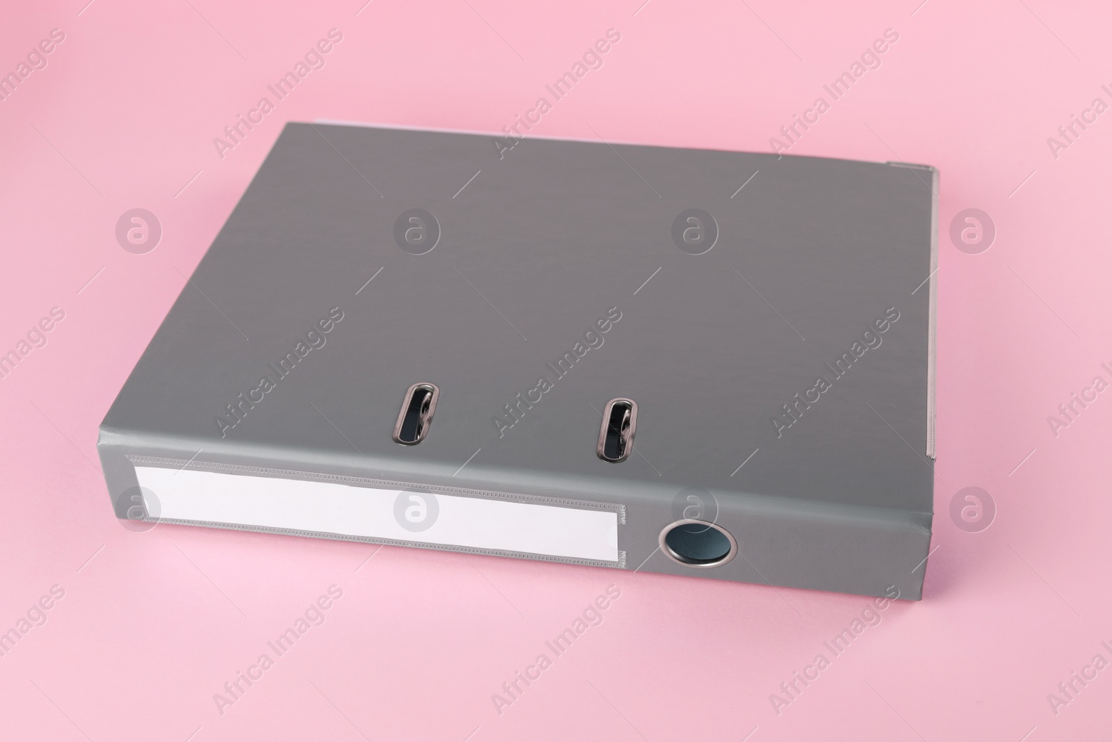 Photo of Grey hardcover office folder on pink background