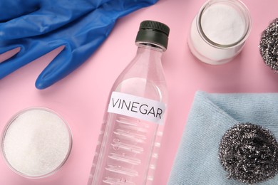 Photo of Eco friendly natural cleaners. Flat lay composition with bottle of vinegar on pink background