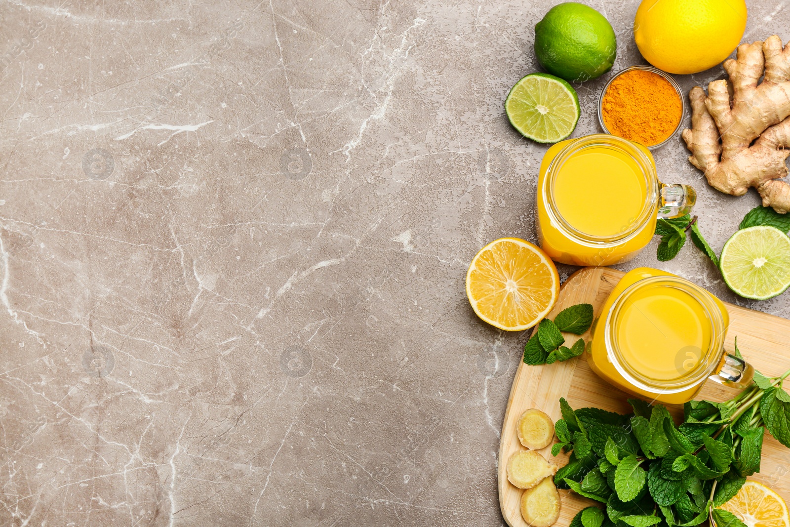 Photo of Flat lay composition with immunity boosting drink on grey table. Space for text