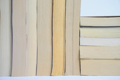 Photo of Collection of different books on light background, closeup