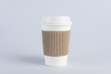 Photo of Paper cup with plastic lid on light background. Coffee to go