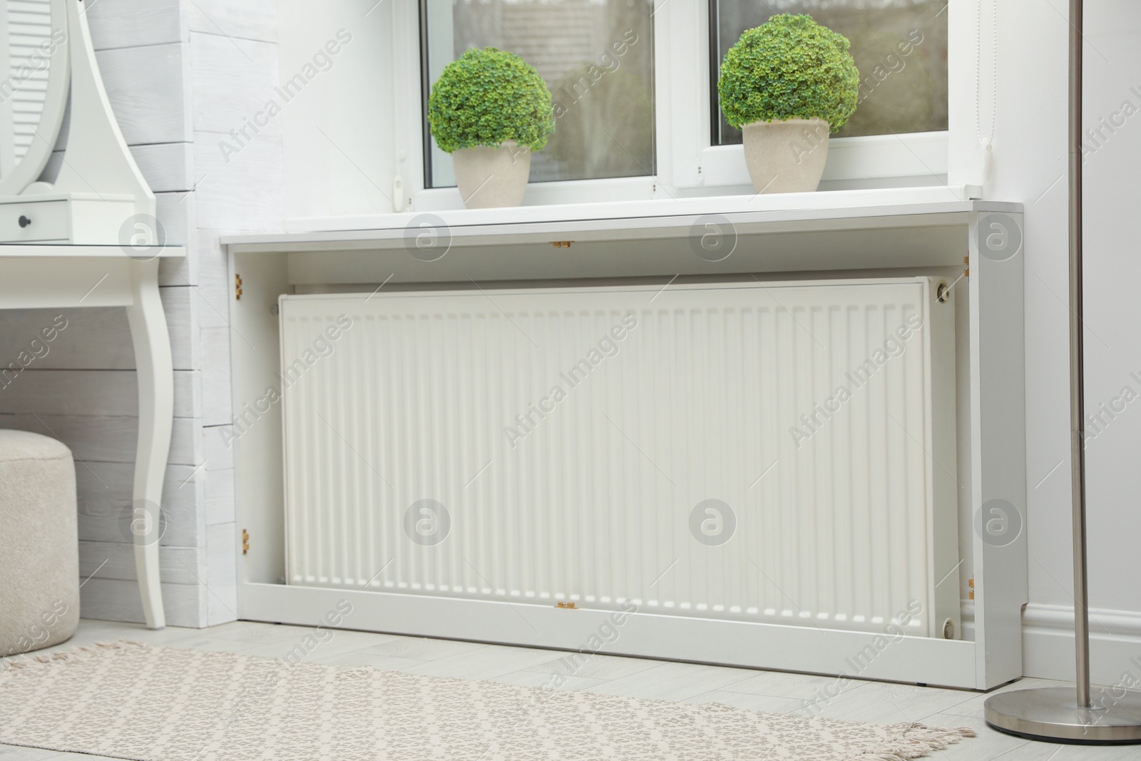 Photo of Modern radiator at home. Central heating system