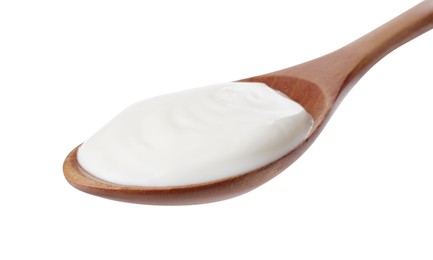 Photo of Wooden spoon with delicious organic yogurt isolated on white