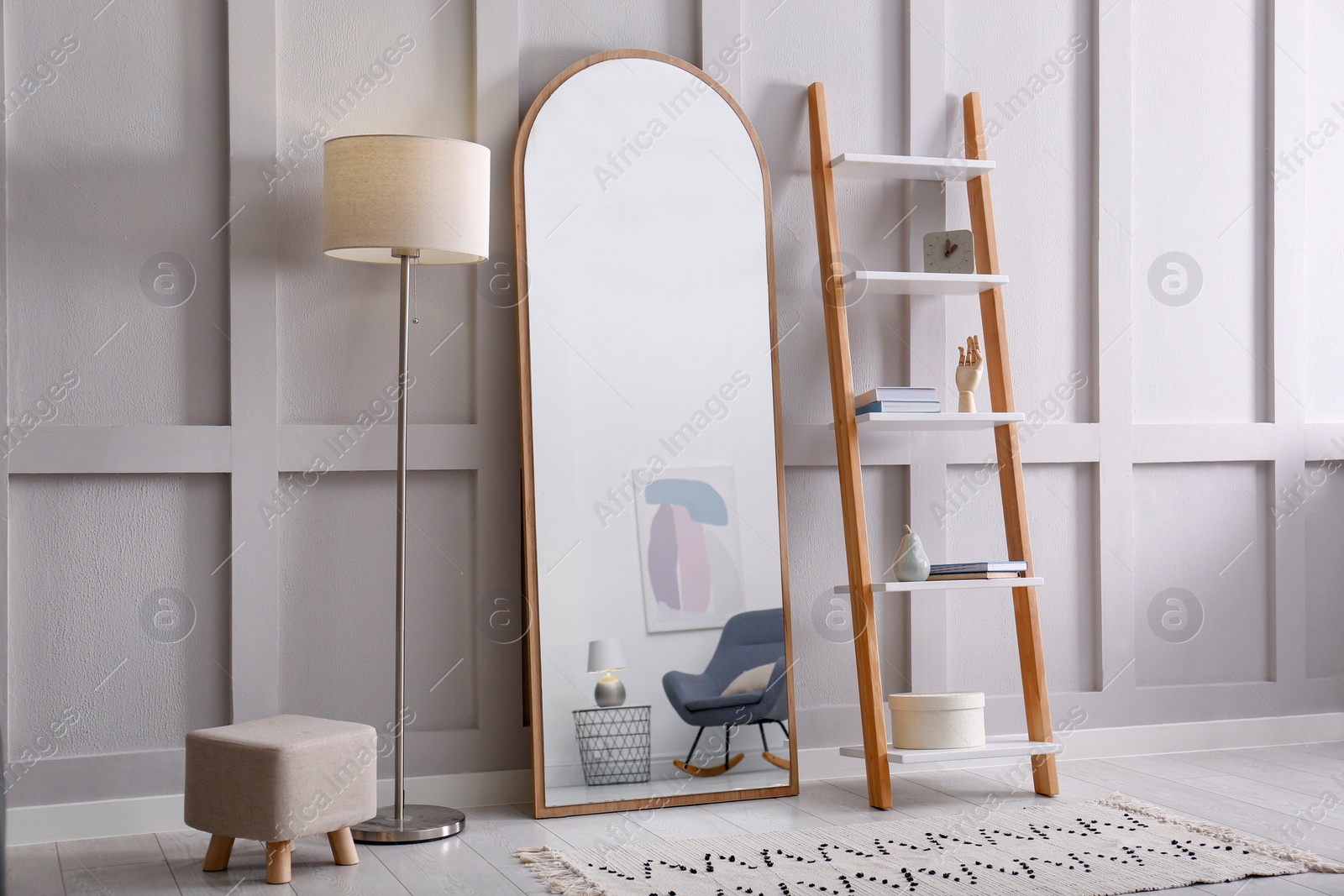 Photo of Large mirror near white wall in light room