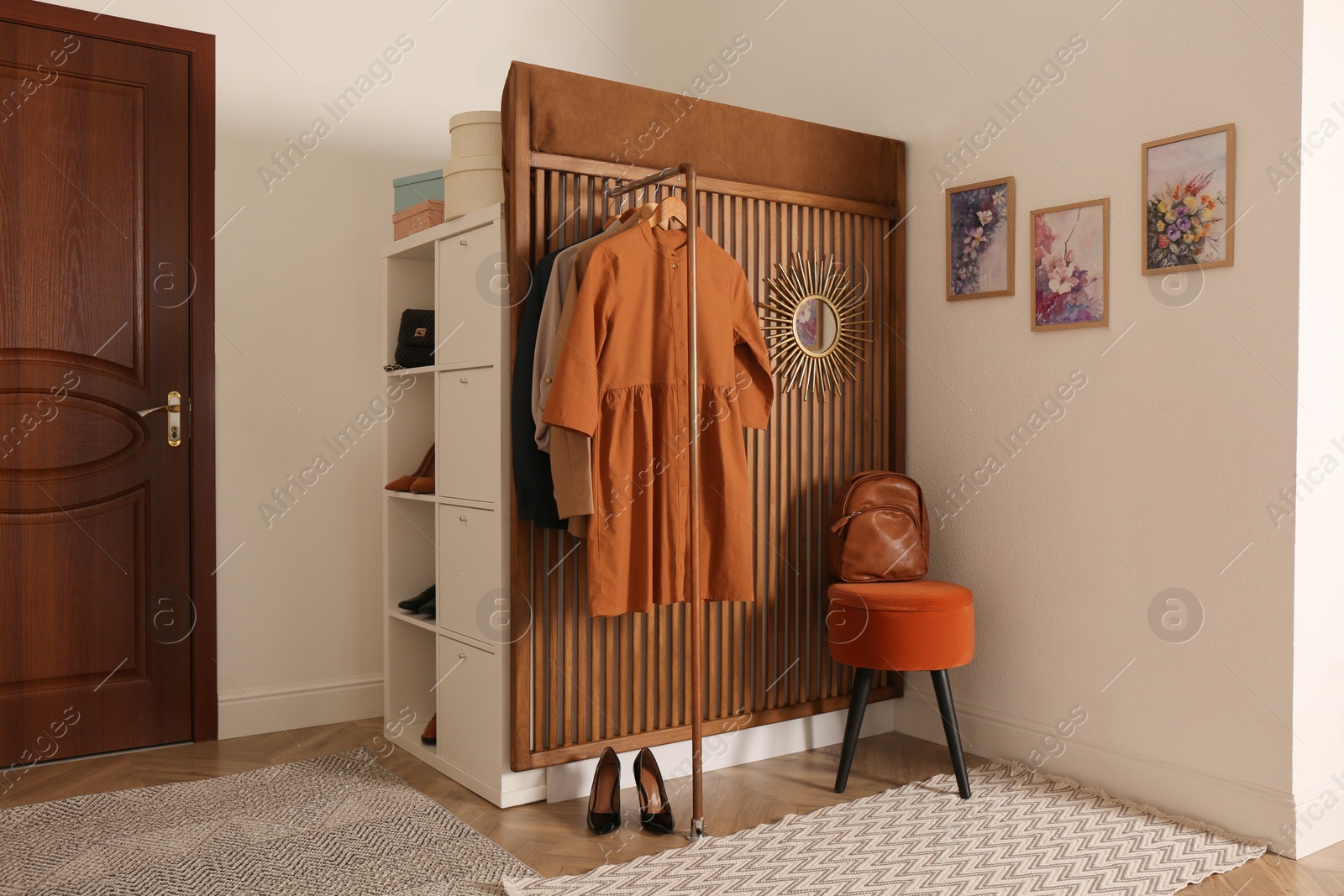 Photo of Modern hallway interior with stylish furniture and clothes rack