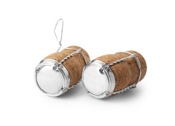Photo of Sparkling wine corks with muselet caps on white background