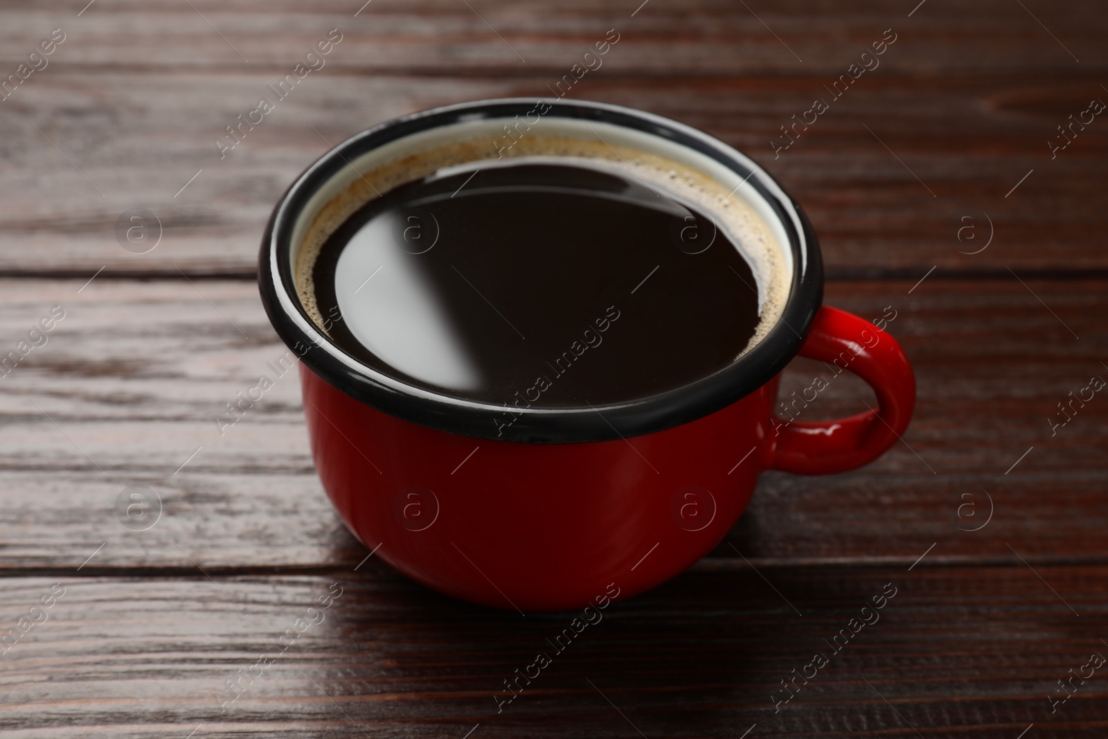 Photo of Cup of aromatic coffee on wooden table, closeup