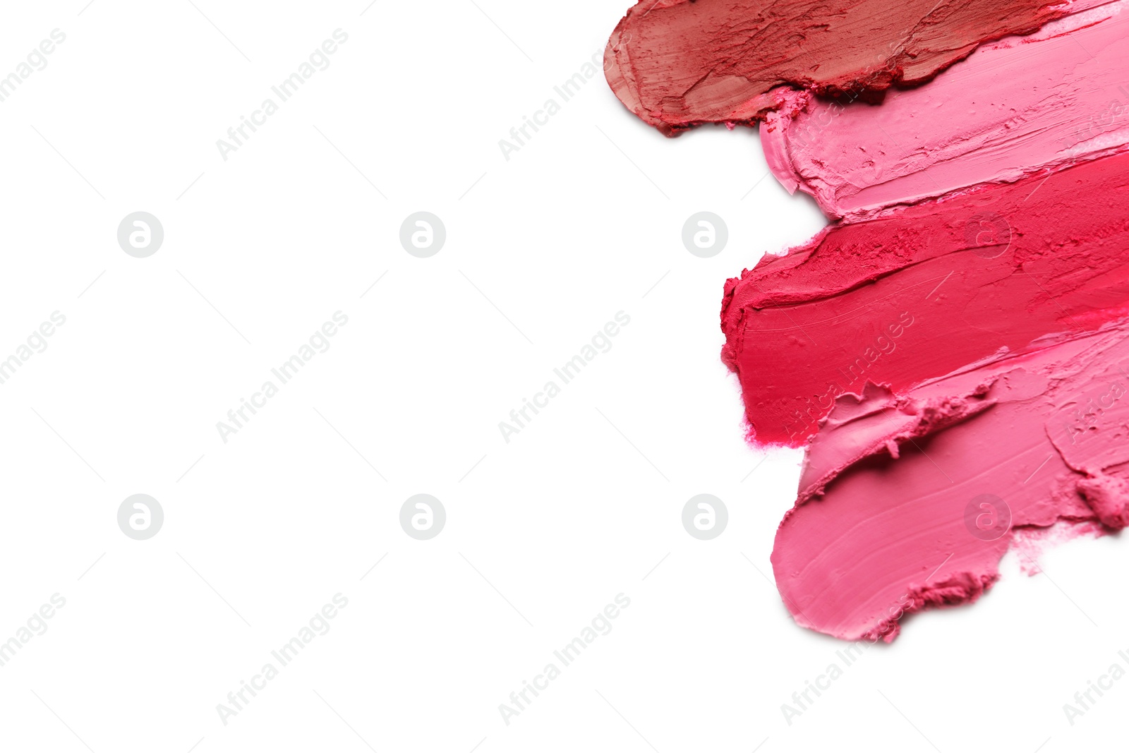 Photo of Smears of bright lipsticks on white background, top view