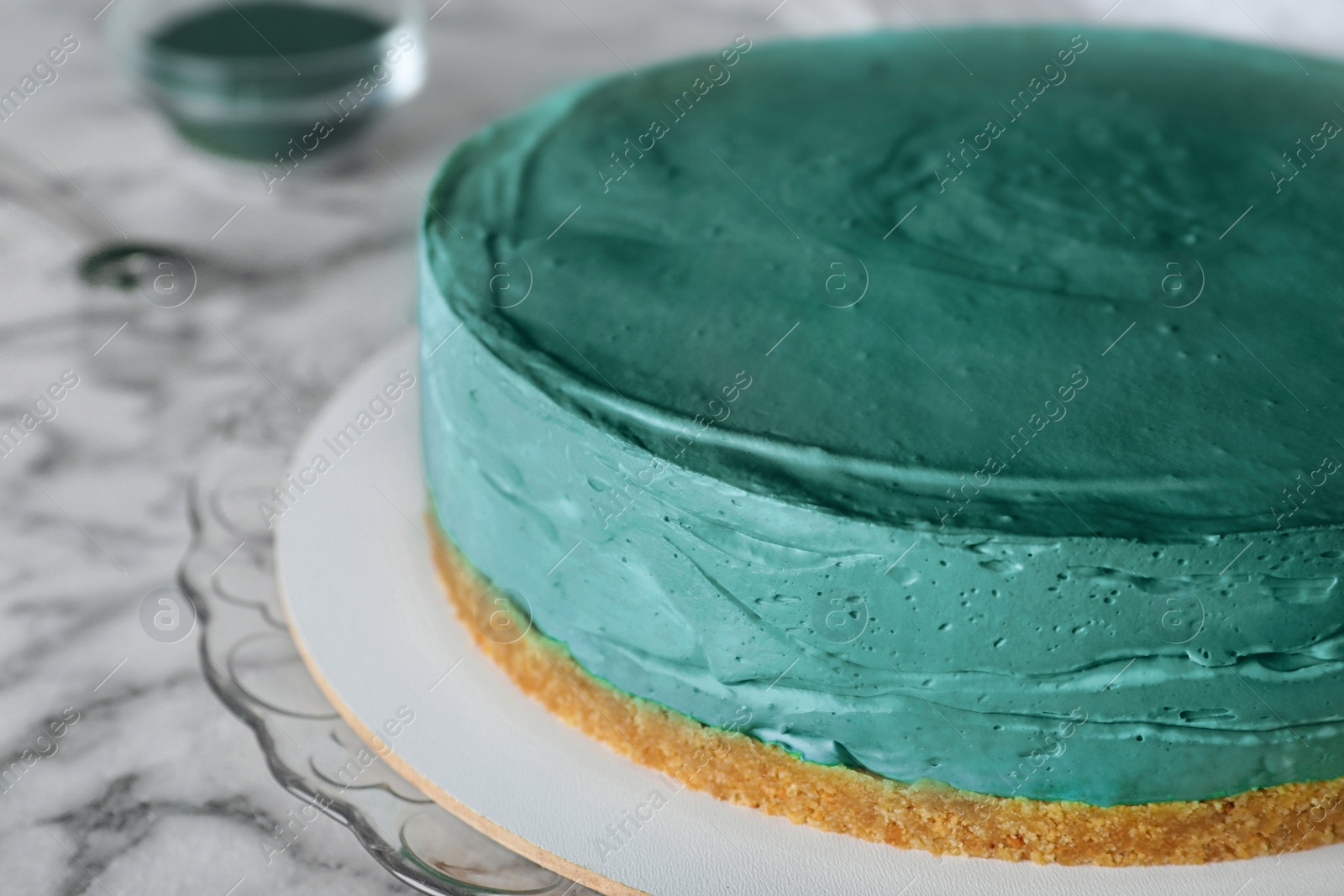 Photo of Delicious homemade spirulina cheesecake on marble table