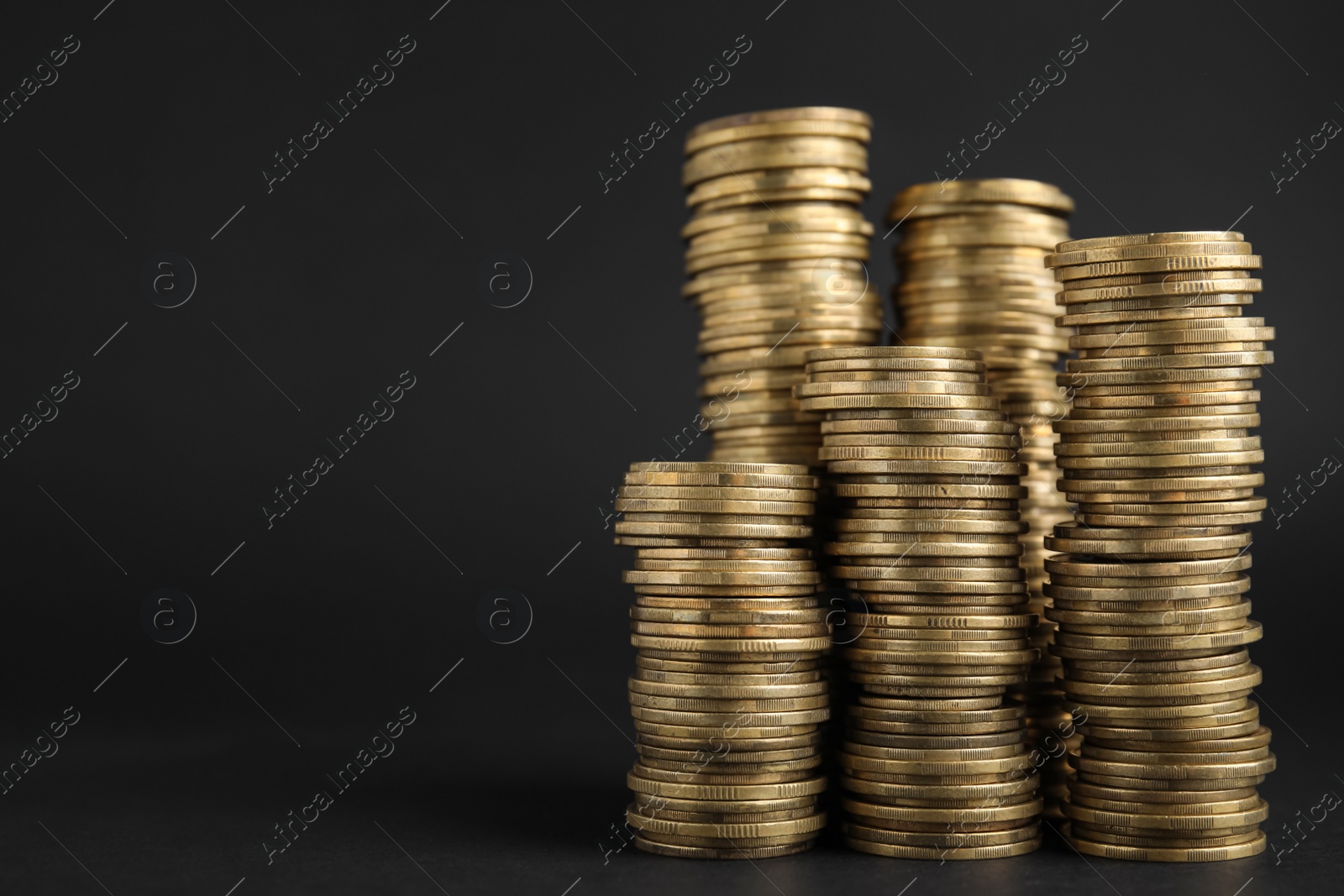 Photo of Many Euro coins stacked on black background, space for text