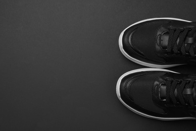 Photo of Pair of stylish shoes on black background, top view. Space for text