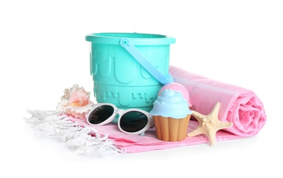 Photo of Set of plastic beach toys, sunglasses and blanket on white background