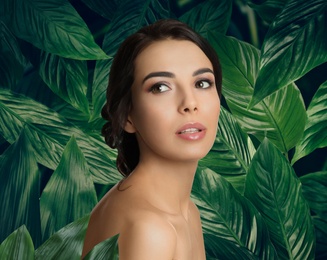 Image of Beautiful young woman and tropical leaves. Spa portrait