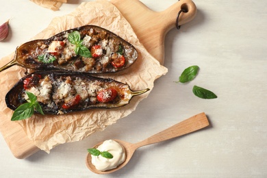 Photo of Flat lay composition with stuffed eggplants on light table