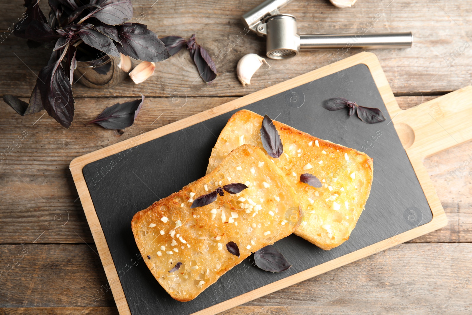 Photo of Flat lay composition with tasty garlic bread on table