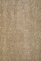 Stylish soft beige carpet as background, top view