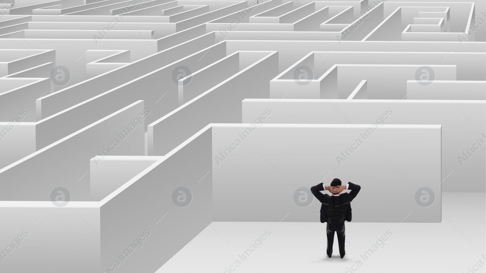 Image of Thoughtful businessman trying to find way out of maze