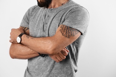 Closeup view of tattooed man on white background